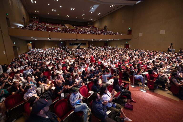 A capacity audience fills Stanford Memorial Auditorium during the 2026 Symposium