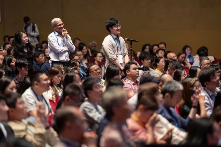 An attendee asks a question from the floor during the 2026 Frontier Symposium
