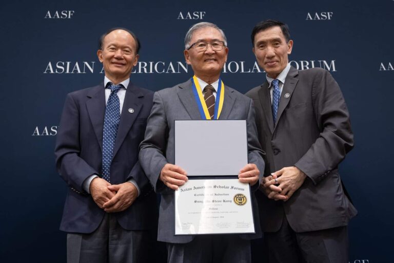 A newly inducted AASF Fellow receives a certificate at the 2026 Fellows Induction