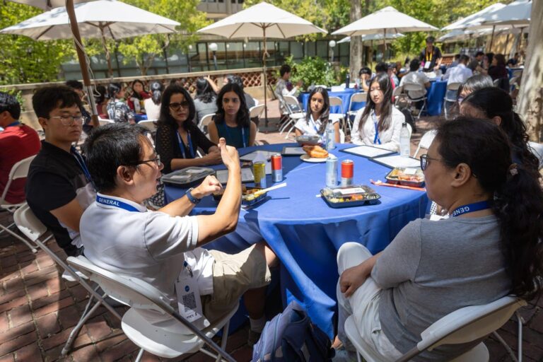 Attendees gather over lunch during the research, mentorship and social roundtables at the 2026 Symposium