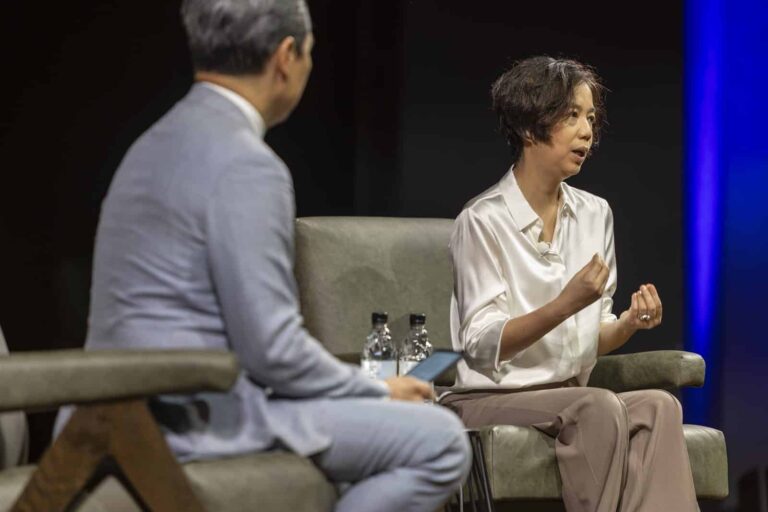 Fei-Fei Li speaks with host Richard Lui during her keynote fireside chat