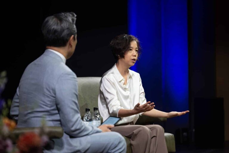 Fei-Fei Li in conversation with NBC and MSNBC anchor Richard Lui at the 2026 Pioneer Symposium