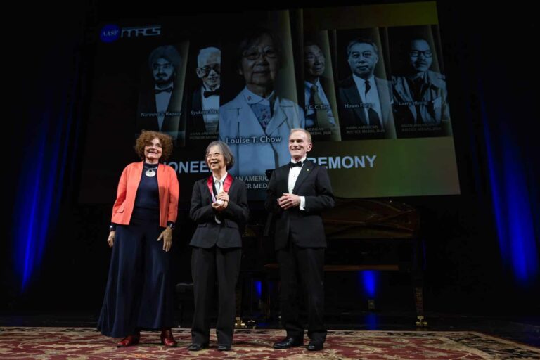 A 2026 Asian American Pioneer Medal is presented on stage