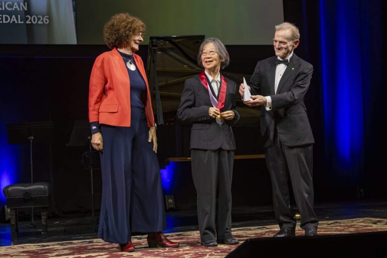 A medalist is presented with the 2026 Asian American Pioneer Medal